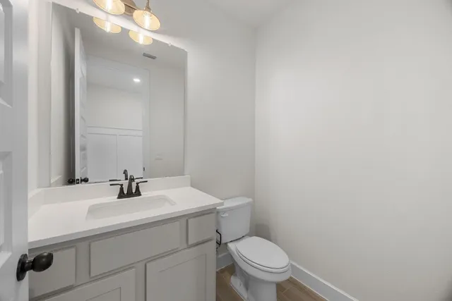a bathroom with a sink toilet and a mirror
