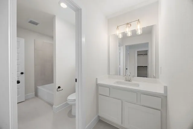 a view of a livingroom with furniture wooden floor windows