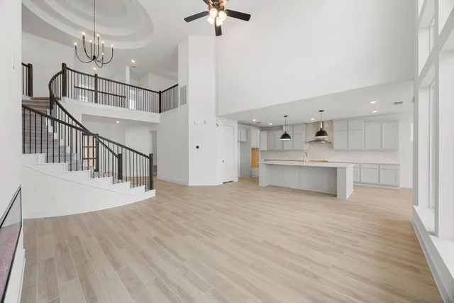 a view of a kitchen with cabinets and wooden floor