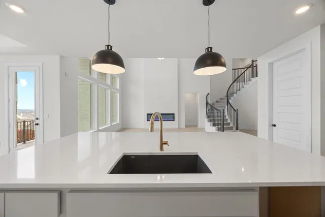 a cabinet with a vase and a chandelier fan