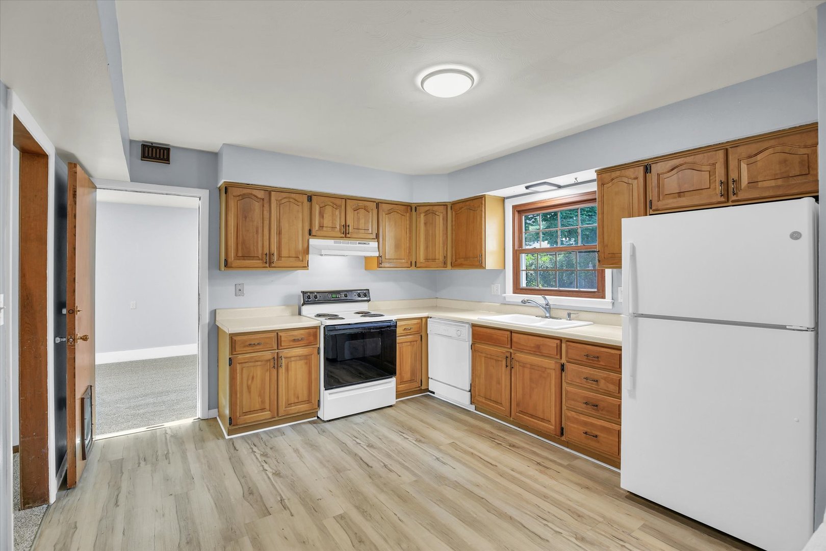 2107 Barberry Drive Champaign, IL 61821 - Photo 4 of 37 a kitchen with granite countertop a refrigerator stove top oven and sink