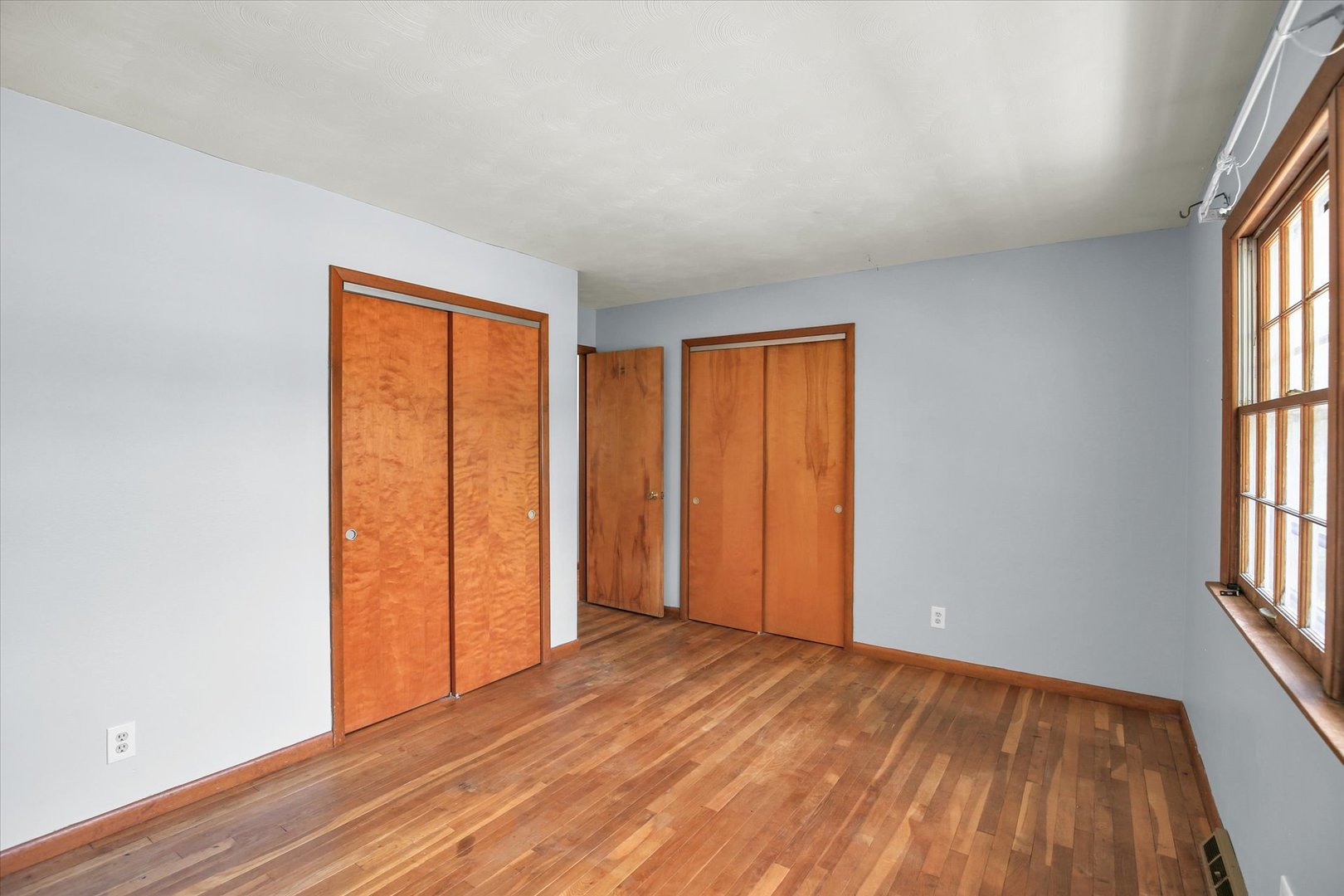 2107 Barberry Drive Champaign, IL 61821 - Photo 7 of 37 an empty room with wooden floor and windows