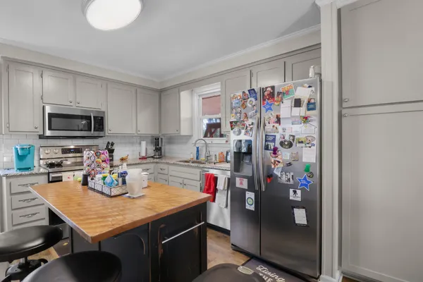 a kitchen with a refrigerator and a sink