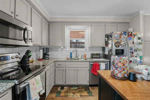 a kitchen with a sink stove and cabinets