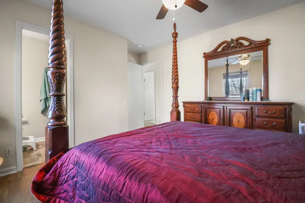 a bedroom with a large bed and a chandelier