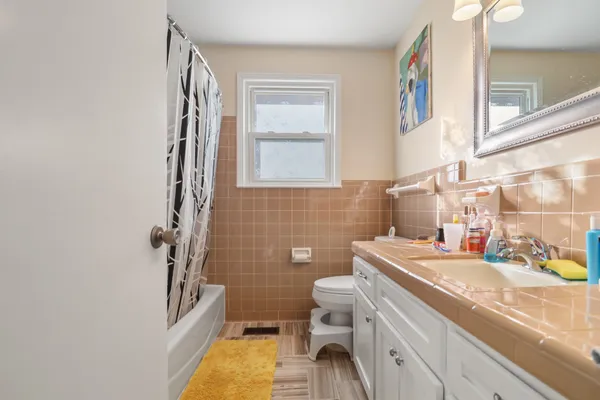 a bathroom with a sink a toilet and a mirror