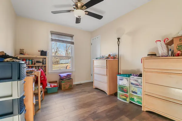 a view of a bedroom with baby bed and toys
