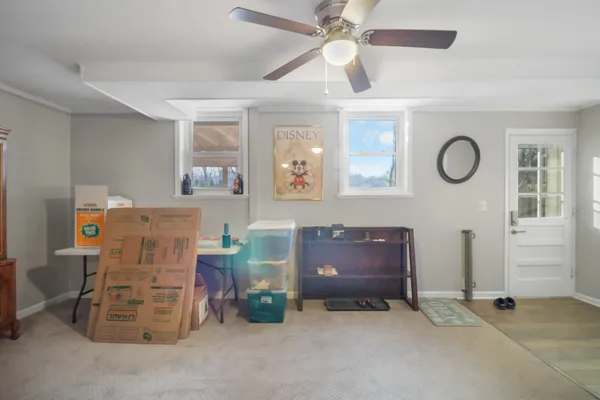a room with furniture and a chandelier fan