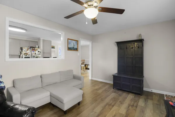 a living room with furniture and a wooden floor