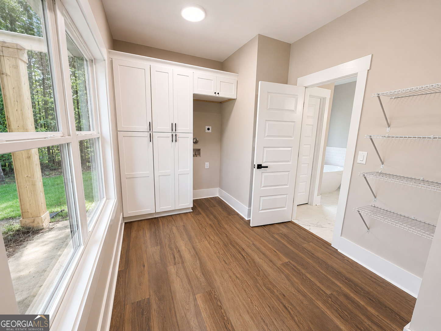 238 Signing Tree Trail Clarkesville, GA 30523 - Photo 15 of 37 Featuring 2 laundry areas with a full laundry room upstairs and smaller laundry area in the primary closet.