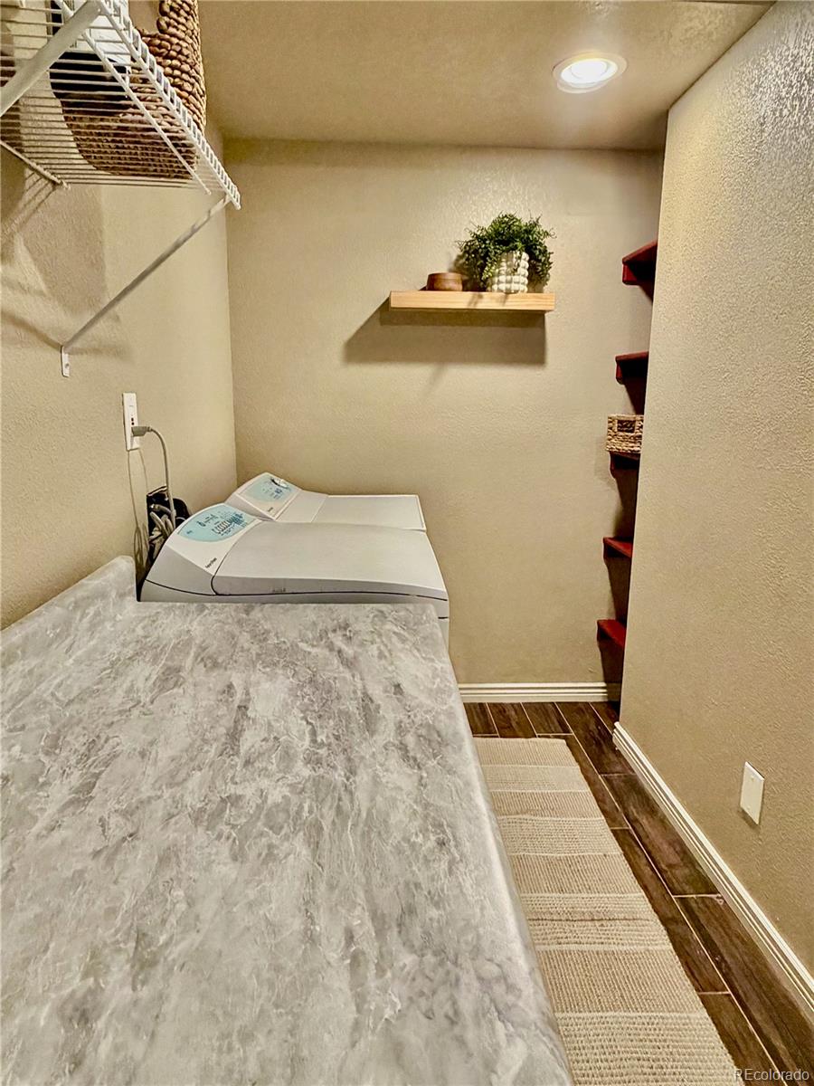 3495 Amber Sun Circle Castle Rock, CO 80108 - Photo 25 of 29 a bedroom with a bed and wooden floor