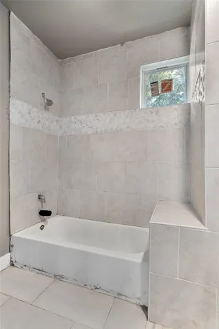 a bathroom with a bathtub and a shower