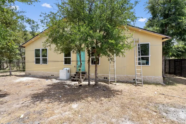 a backyard of a house with table and chairs