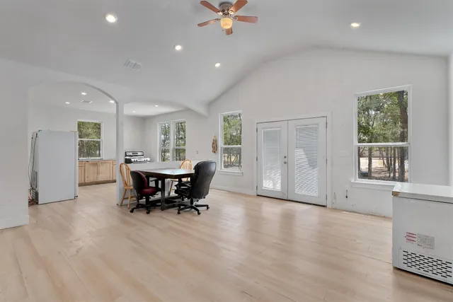 a view of a dining room with furniture and chandelier