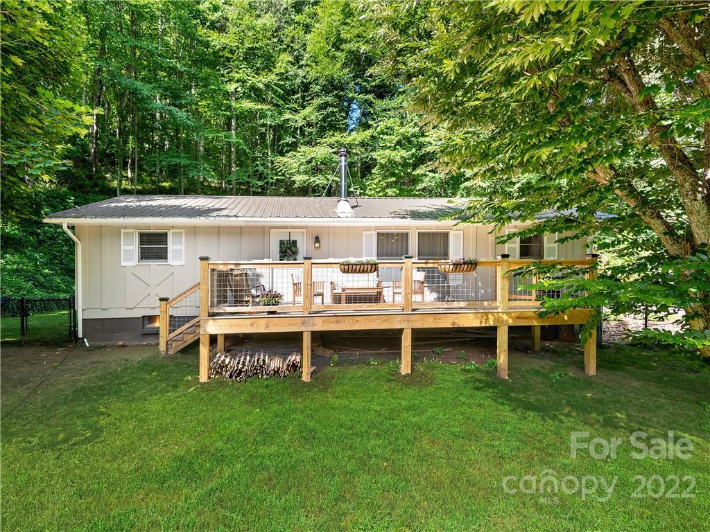 1908 Kims Cove Road Canton, NC 28716 - Photo 1 of 31 a view of a house with a backyard and chairs