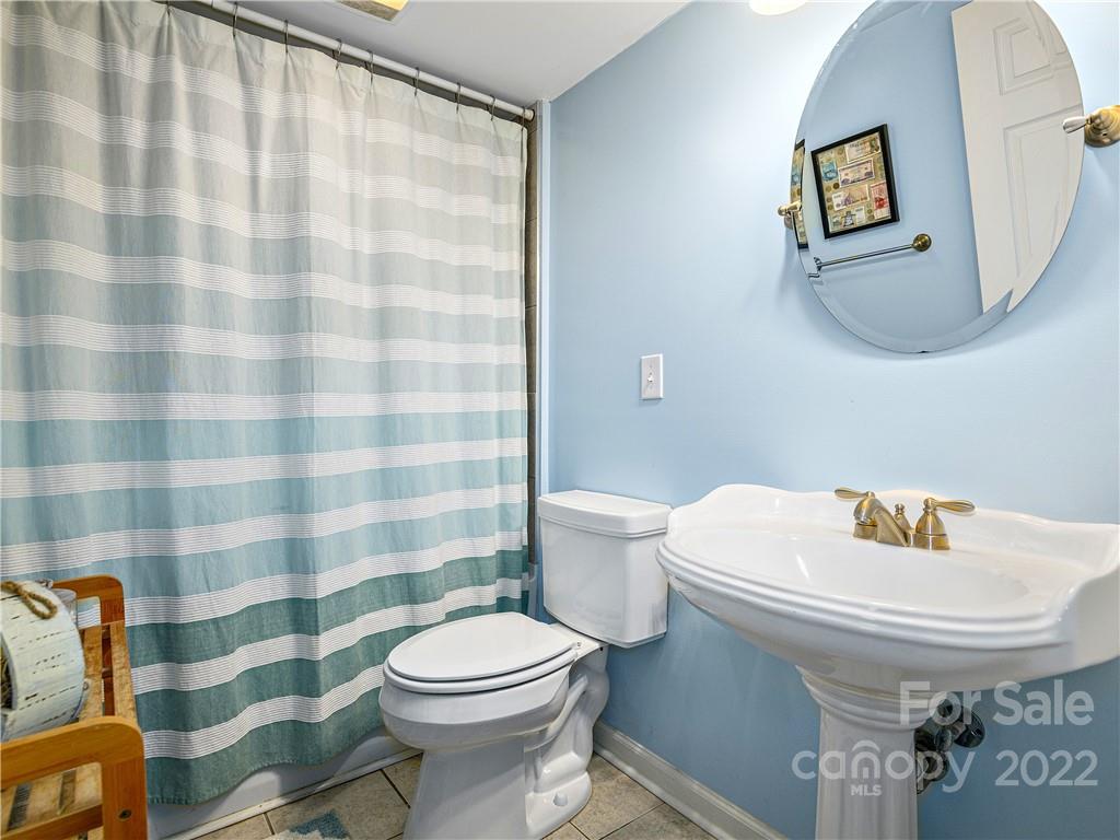 1908 Kims Cove Road Canton, NC 28716 - Photo 16 of 31 a white toilet sitting next to a bathroom sink