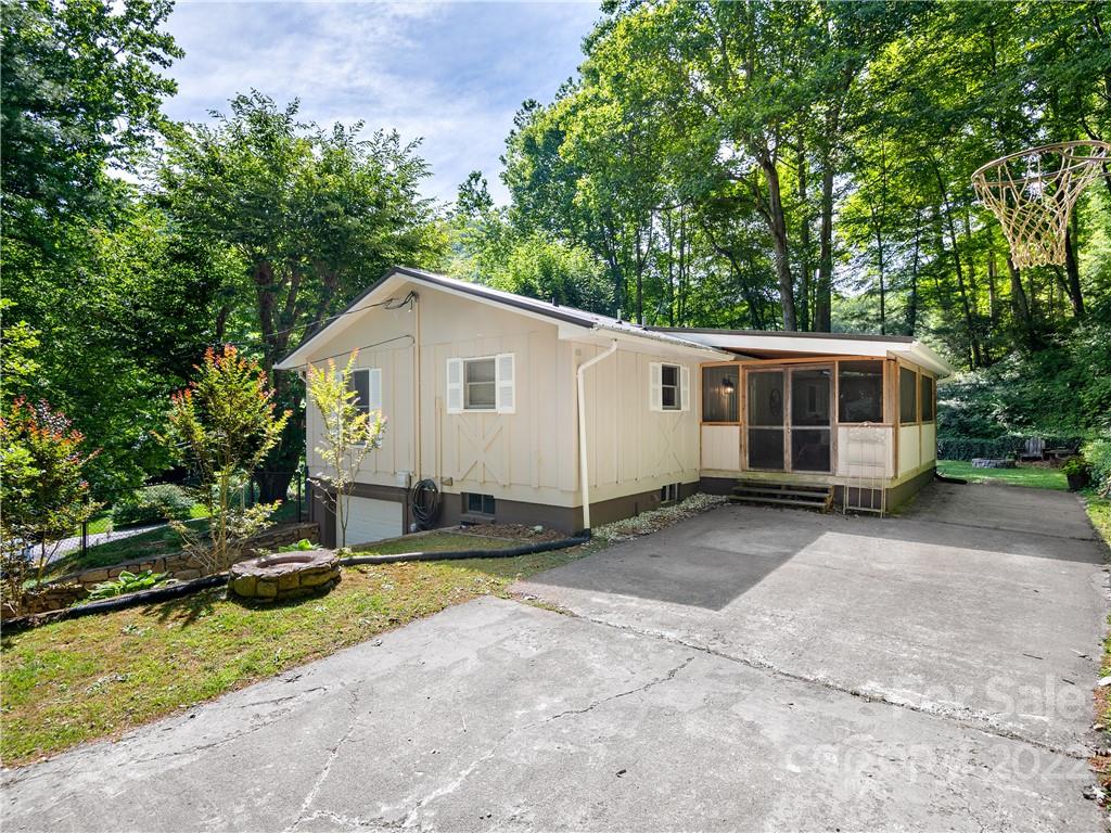 1908 Kims Cove Road Canton, NC 28716 - Photo 25 of 31 a view of house with backyard and sitting area