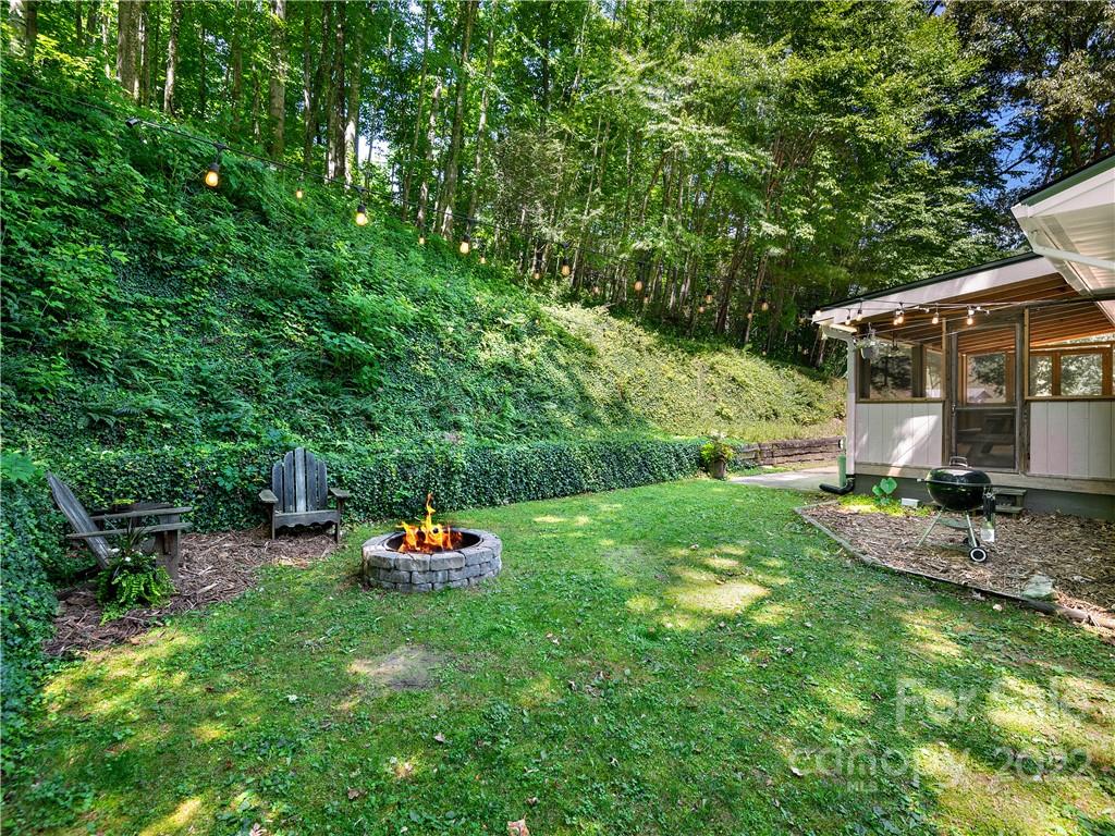1908 Kims Cove Road Canton, NC 28716 - Photo 26 of 31 a backyard of a house with yard barbeque oven and outdoor seating