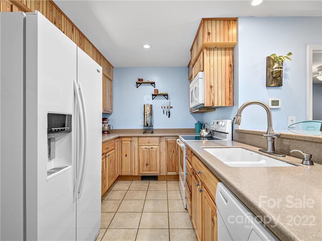 1908 Kims Cove Road Canton, NC 28716 - Photo 8 of 31 a kitchen with a sink a stove a refrigerator and a sink
