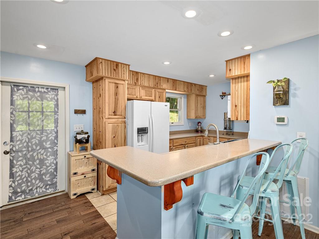 1908 Kims Cove Road Canton, NC 28716 - Photo 10 of 31 a large kitchen with stainless steel appliances a large counter top and wooden floors