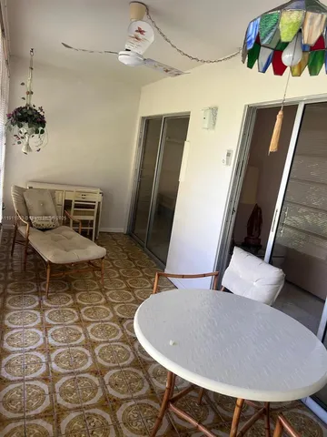 a view of a dining room with furniture and window