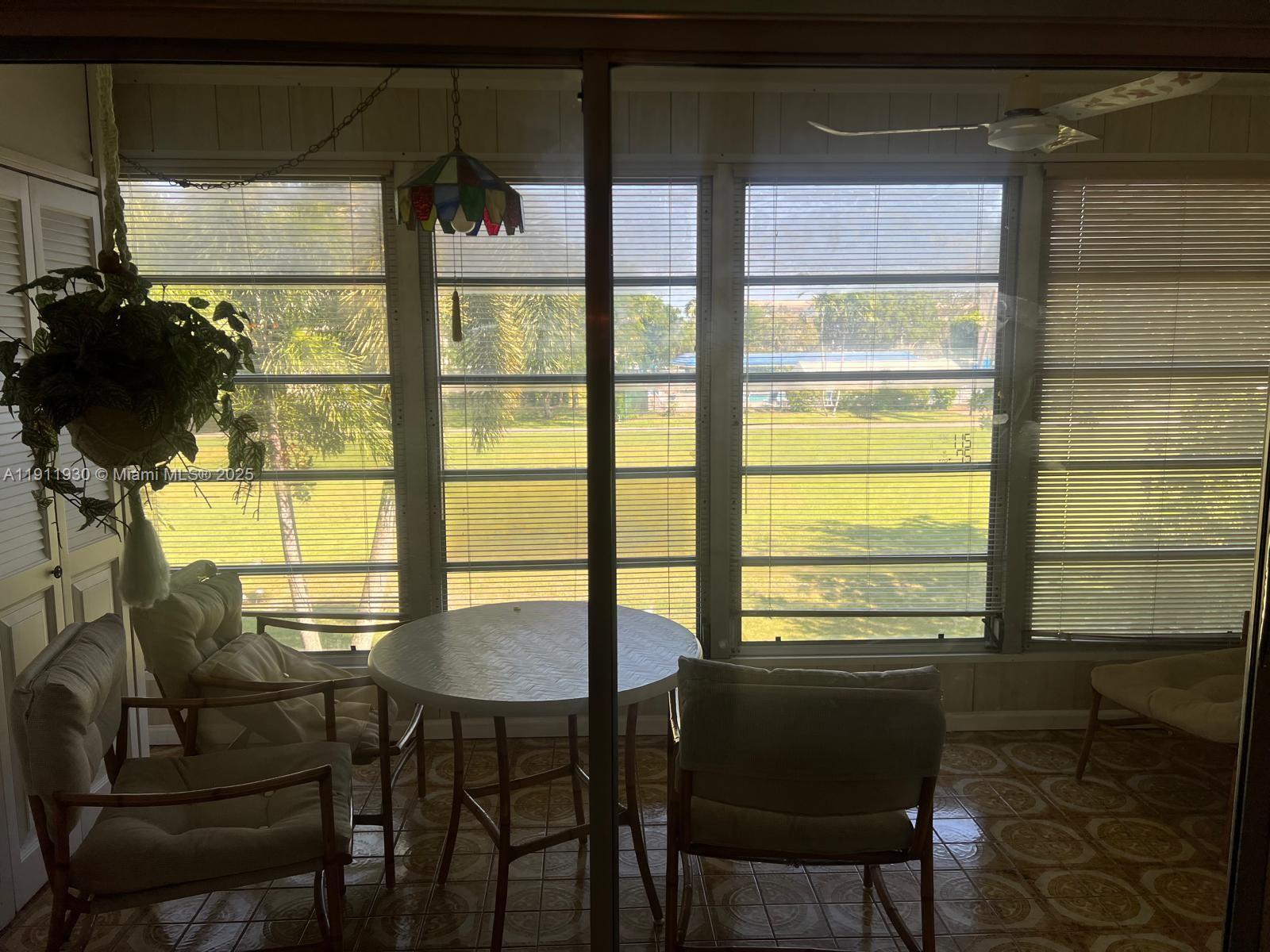 3102 Portofino Point, Unit M2 Coconut Creek, FL 33066 - Photo 14 of 26 a view of a dining room with furniture and window