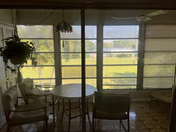 a view of a dining room with furniture and window