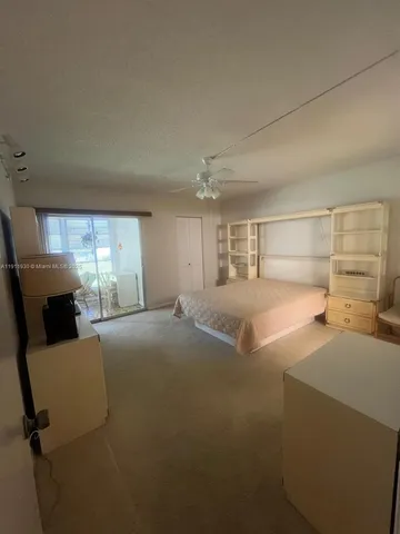 a large bedroom with a bed and dresser