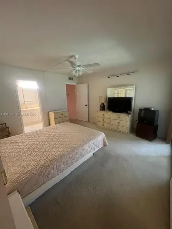 a large bedroom with a bed and dresser