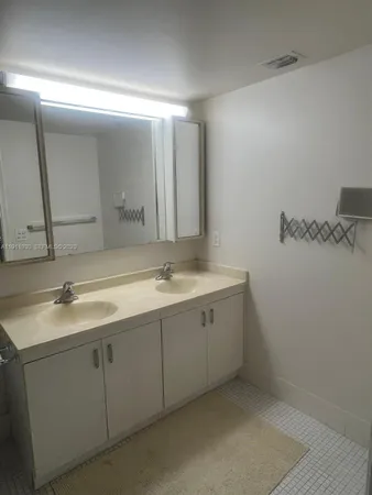 a bathroom with a double vanity sink and mirror