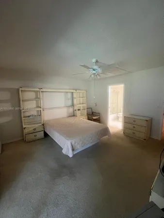 a spacious bedroom with a bed and window