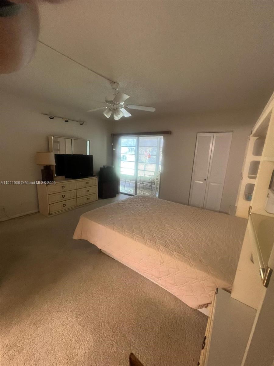 3102 Portofino Point, Unit M2 Coconut Creek, FL 33066 - Photo 23 of 26 a large bed sitting in a room next to a window
