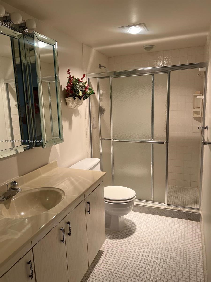 3102 Portofino Point, Unit M2 Coconut Creek, FL 33066 - Photo 24 of 26 a bathroom with a sink a toilet and shower