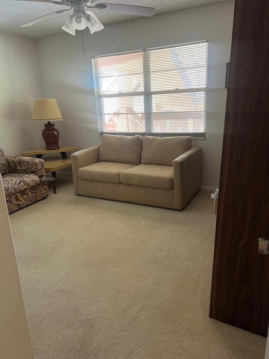 3102 Portofino Point, Unit M2 Coconut Creek, FL 33066 - Photo 25 of 26 a living room with furniture and a window