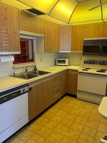 a bathroom with a sink and a refrigerator