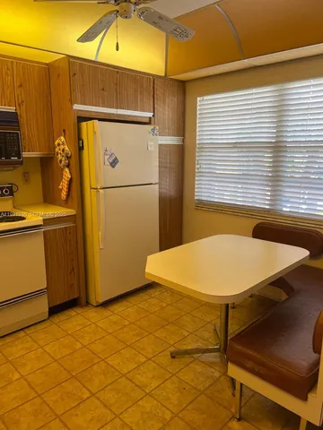 a bathroom with a sink and a refrigerator