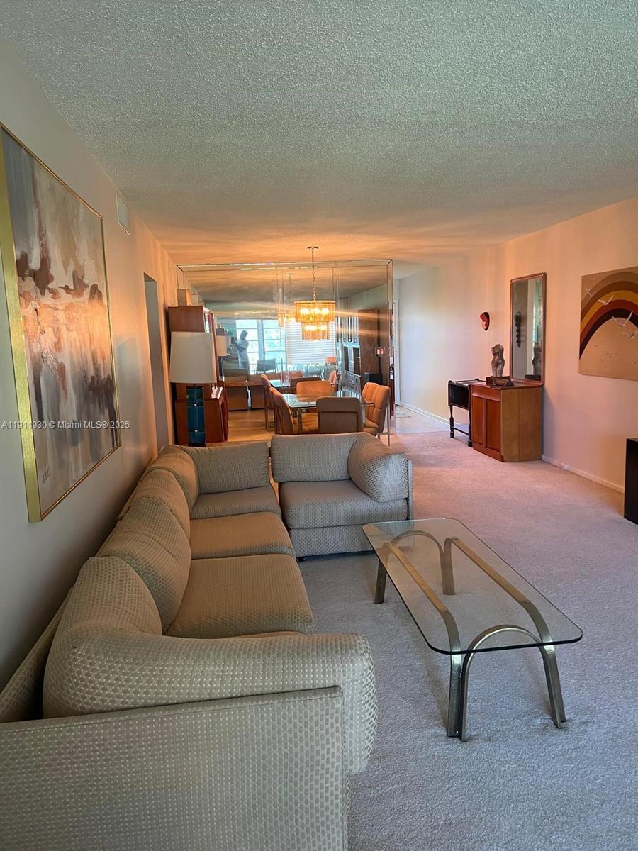 3102 Portofino Point, Unit M2 Coconut Creek, FL 33066 - Photo 10 of 26 a living room with furniture and a large window