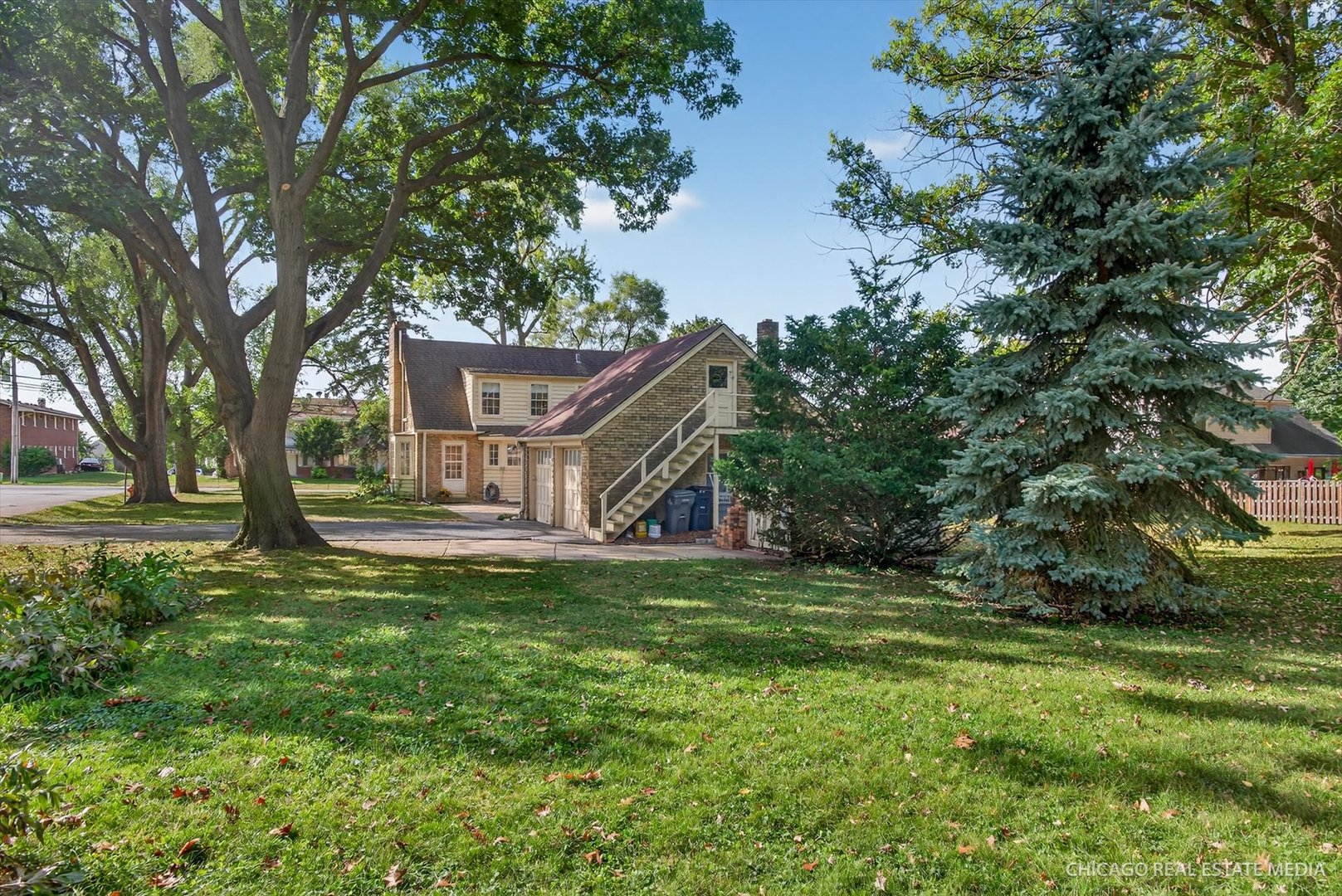 844 Bode Road Elgin, IL 60120 - Photo 26 of 34 a view of a house with a big yard and large trees