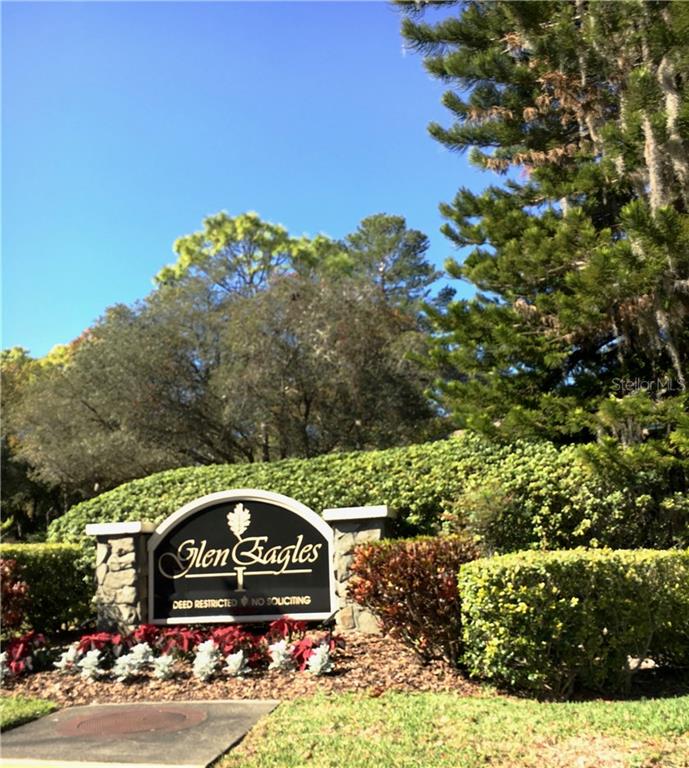 405 Lennox Road West, Unit 405 Palm Harbor, FL 34683 - Photo 1 of 1 a sign that is sitting on a brick wall