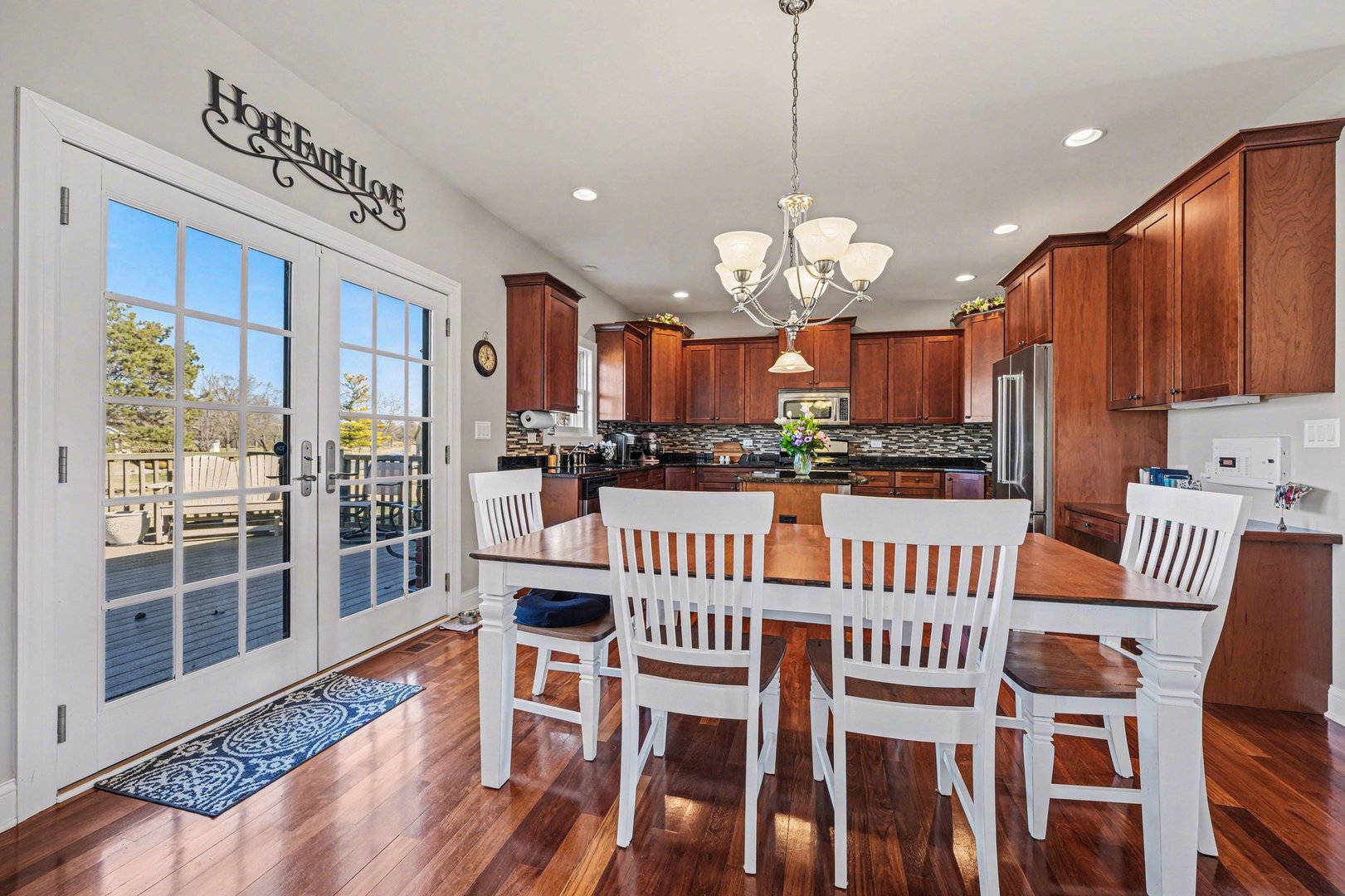 1744 East Offner Road Beecher, IL 60401 - Photo 15 of 49 a view of a dining room with furniture wooden floor and chandelier