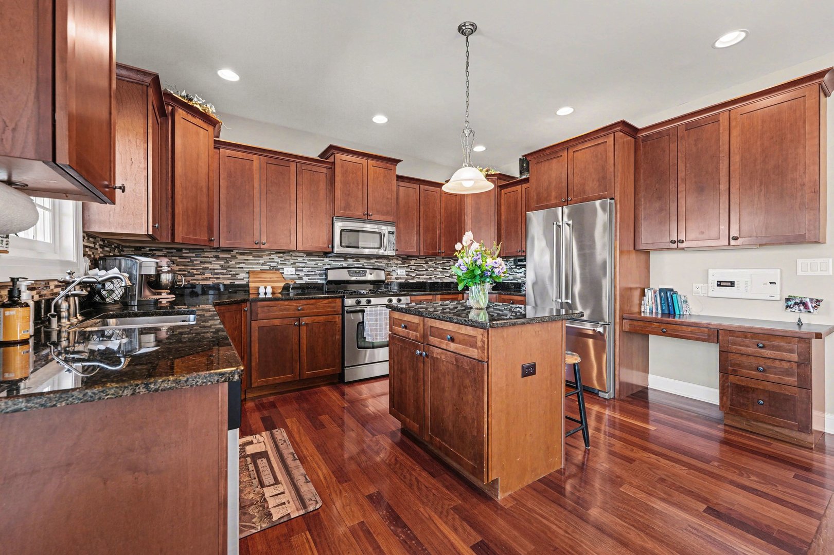 1744 East Offner Road Beecher, IL 60401 - Photo 17 of 49 a kitchen with stainless steel appliances granite countertop a refrigerator a stove top oven a sink dishwasher and a refrigerator with wooden floor