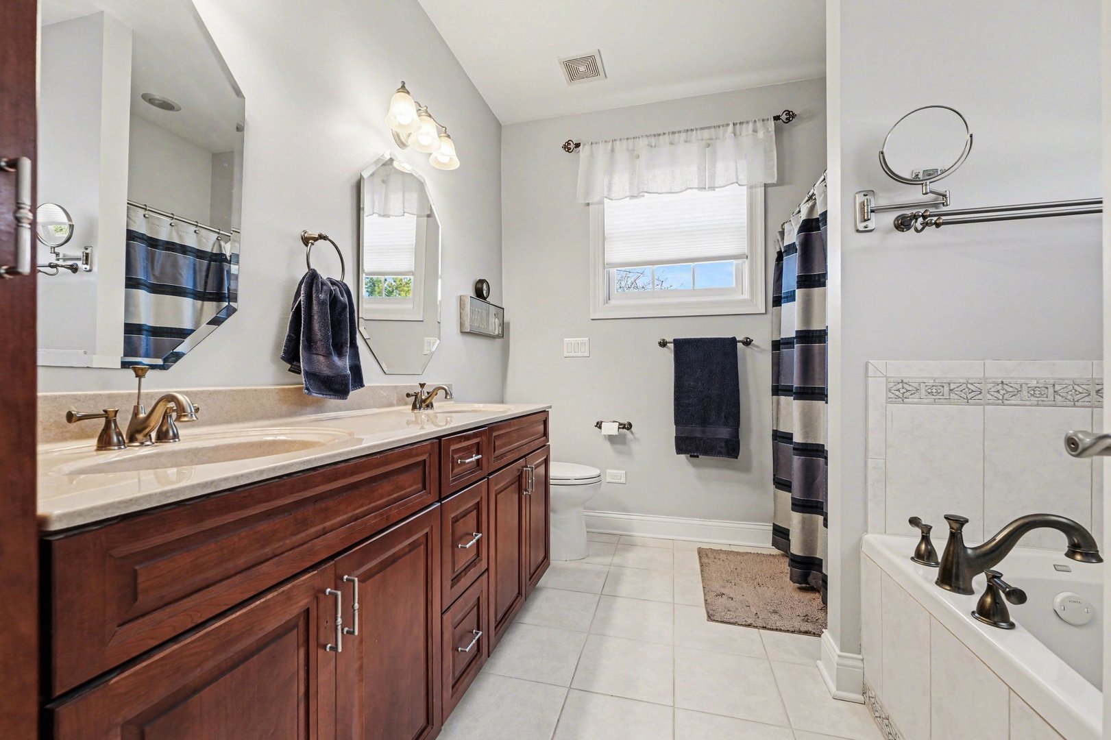 1744 East Offner Road Beecher, IL 60401 - Photo 21 of 49 a spacious bathroom with a double vanity sink a mirror and a bathtub
