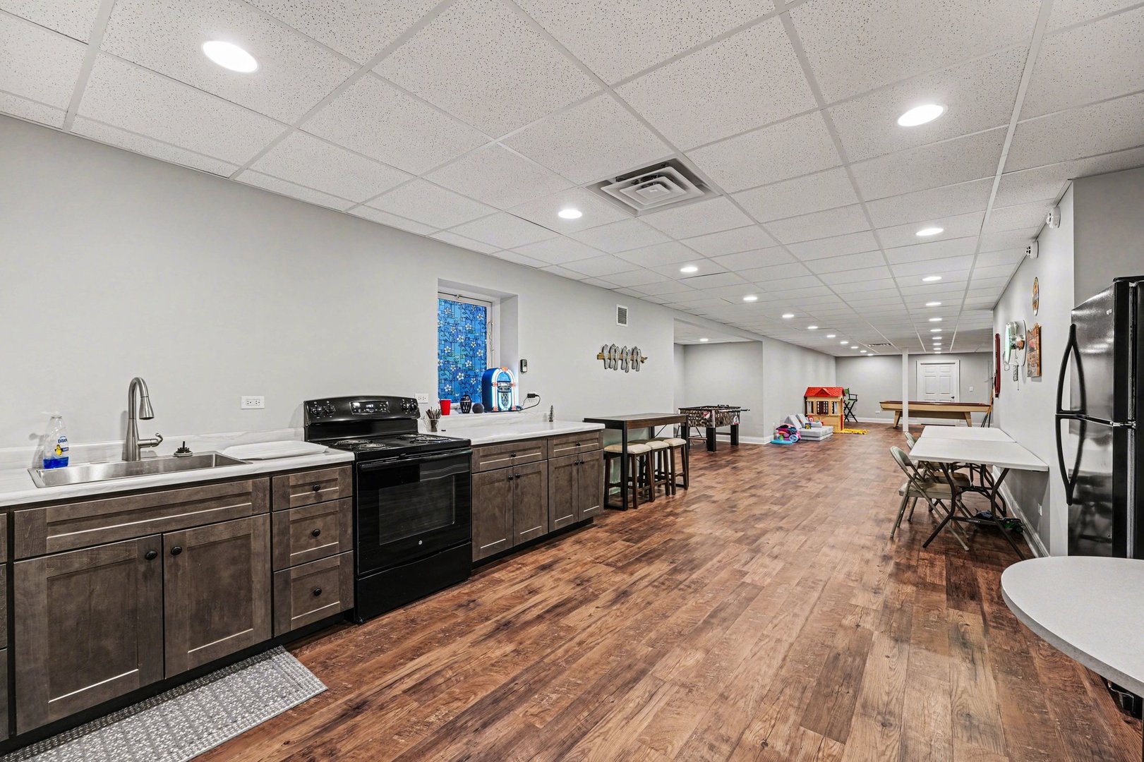 1744 East Offner Road Beecher, IL 60401 - Photo 35 of 49 a kitchen with stainless steel appliances kitchen island granite countertop a sink cabinets and wooden floor