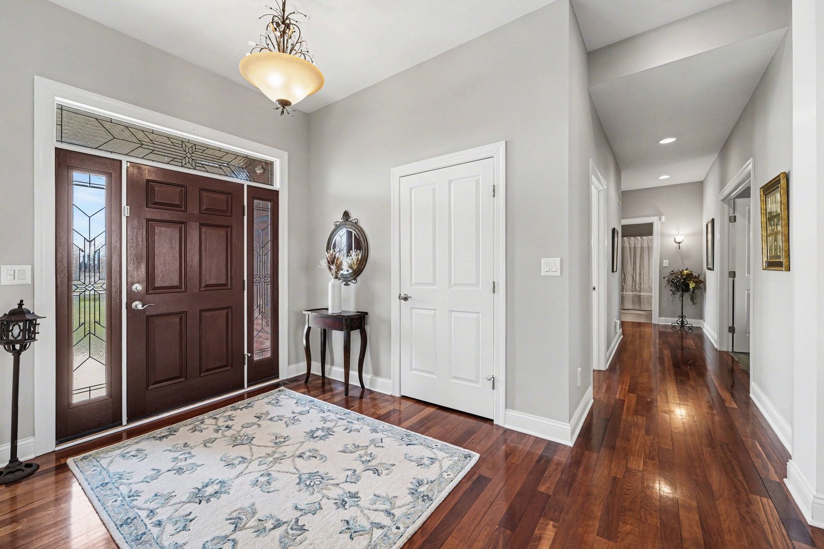 1744 East Offner Road Beecher, IL 60401 - Photo 8 of 49 a view of a hallway with wooden floor and a chandelier