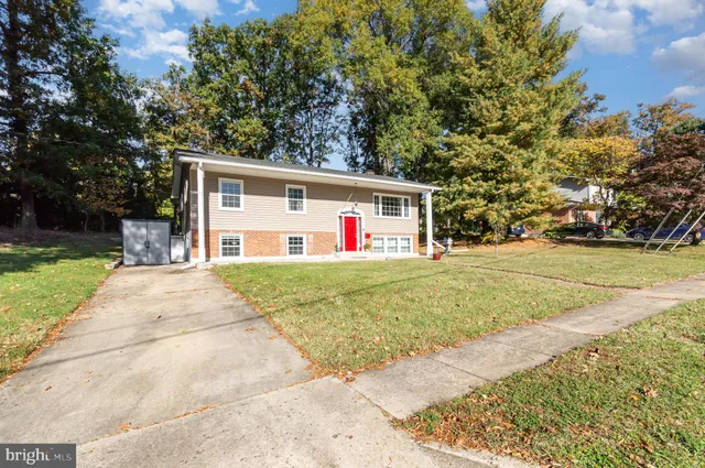 a front view of house with yard and trees around
