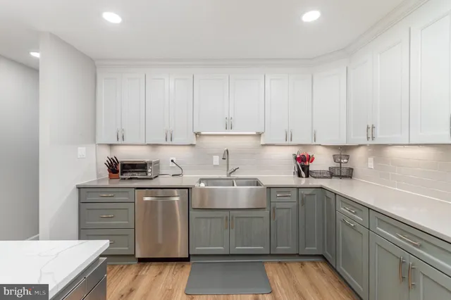 a kitchen with stainless steel appliances granite countertop a sink and cabinets