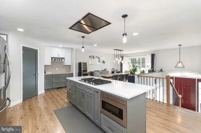 a kitchen with stainless steel appliances granite countertop a stove and a refrigerator