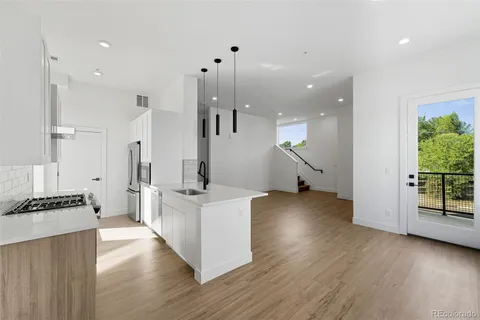a kitchen with stainless steel appliances a refrigerator and a stove