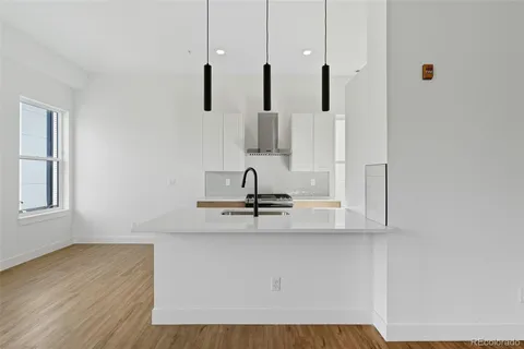 a view of a kitchen with wooden floor