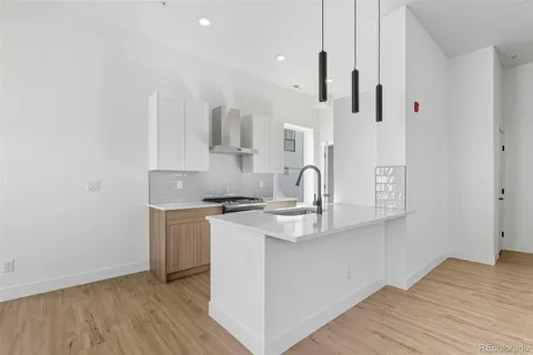 a kitchen with stainless steel appliances a white stove top oven and a sink